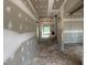 Hallway with drywall and view of unfinished staircase and window at 194 Landon Ridge, Sanford, NC 27330