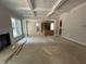 Open-concept living room with coffered ceilings, fireplace, and view of kitchen at 194 Landon Ridge, Sanford, NC 27330