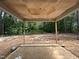 Covered patio featuring exposed beams and view of trees at 194 Landon Ridge, Sanford, NC 27330