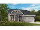 Charming one-story home featuring stone accents, well-manicured lawn, and a two-car garage at 2000 Clydner Dr, Apex, NC 27523