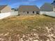 A grassy backyard enclosed by a white fence offers privacy and outdoor space at 2079 Alderman Way, Creedmoor, NC 27522