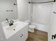 Bright bathroom featuring modern fixtures, a shower-tub combo, and white cabinets at 2079 Alderman Way, Creedmoor, NC 27522