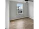 An empty bedroom featuring hardwood floors and a street view through the window at 2079 Alderman Way, Creedmoor, NC 27522
