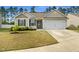 Charming single-story home featuring a two-car garage, well-maintained lawn, and classic neutral siding at 2079 Alderman Way, Creedmoor, NC 27522