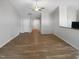 Open-concept living room with a ceiling fan and wood-look flooring at 2079 Alderman Way, Creedmoor, NC 27522