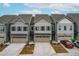 An aerial view showcases three townhomes, highlighting their design, curb appeal, and landscaping at 2140 Stegemann St, Apex, NC 27502