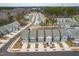 Beautiful aerial view of townhomes with attached garages in a well-planned community near a wooded area at 2140 Stegemann St, Apex, NC 27502