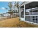 A backyard view from inside a screened porch, showcasing neighboring homes and a well-maintained lawn at 2140 Stegemann St, Apex, NC 27502