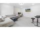 Bright, finished basement with plush carpet, a sectional sofa, workspace, and entertainment setup at 2140 Stegemann St, Apex, NC 27502