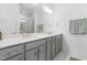 Modern bathroom featuring double sinks, quartz countertops, and a walk-in shower at 2140 Stegemann St, Apex, NC 27502