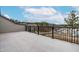 A spacious deck with black metal railings provides stunning neighborhood views under a bright, cloudy sky at 2140 Stegemann St, Apex, NC 27502