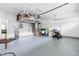 Well-organized garage with epoxy flooring, overhead storage rack, and ample space for vehicles and storage at 2140 Stegemann St, Apex, NC 27502