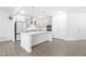 Spacious kitchen featuring a center island, stainless steel appliances, and contemporary cabinetry at 2140 Stegemann St, Apex, NC 27502