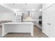 Modern kitchen with a large island, stainless steel appliances, and stylish pendant lighting at 2140 Stegemann St, Apex, NC 27502