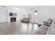 Bright living room features a fireplace, TV, and ample seating with neutral color palette at 2140 Stegemann St, Apex, NC 27502