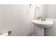 Elegant pedestal sink and modern fixtures give a touch of class to this powder room at 2140 Stegemann St, Apex, NC 27502