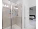 Bathroom shower features tiled walls, glass enclosure, and built-in shelving for toiletries at 2140 Stegemann St, Apex, NC 27502