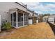 Backyard view of multiple screened-in porches and a row of townhomes at 2140 Stegemann St, Apex, NC 27502