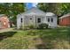 Well-maintained home with a covered front porch, a manicured lawn, and mature landscaping at 2206 Guess Rd, Durham, NC 27705