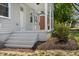 Inviting front porch with white columns and steps, enhancing the curb appeal of the home at 2206 Guess Rd, Durham, NC 27705