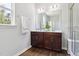 Bathroom featuring dual sink vanity, large mirror, and glass shower enclosure at 244 Potomac River St, Garner, NC 27529