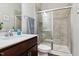Modern bathroom featuring sleek vanity, framed mirror, and glass enclosed tiled shower at 244 Potomac River St, Garner, NC 27529