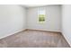 Cozy bedroom featuring plush carpet, a bright window, and neutral paint at 244 Potomac River St, Garner, NC 27529