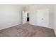 Bedroom with neutral walls, plush carpet, a walk-in closet, and a view to the bathroom at 244 Potomac River St, Garner, NC 27529