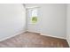 Bedroom with neutral walls and carpet and window view of greenery at 244 Potomac River St, Garner, NC 27529