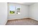 Bedroom with view of neighborhood seen through large windows at 244 Potomac River St, Garner, NC 27529