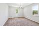 Bedroom with neutral walls and carpet and two large windows at 244 Potomac River St, Garner, NC 27529