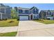 Charming two-story home features a spacious driveway, manicured lawn, and blue siding at 244 Potomac River St, Garner, NC 27529
