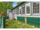 Exterior of home showcasing unique architectural details, a small deck, and lush backyard at 2440 Glencoe St, Burlington, NC 27217