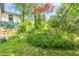 Lush backyard featuring vibrant greenery, mature trees, and colorful flower beds, perfect for outdoor enjoyment at 2440 Glencoe St, Burlington, NC 27217