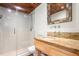 Modern bathroom with a glass-enclosed shower, granite countertop, decorative mirror, and tile flooring at 2440 Glencoe St, Burlington, NC 27217