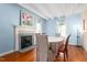 Bright dining room with hardwood floors, fireplace, and ample seating around a round table at 2440 Glencoe St, Burlington, NC 27217