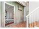Entryway with white staircase, tile flooring, rustic wood paneling and a view into another room at 2440 Glencoe St, Burlington, NC 27217