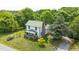 Well-maintained two-story home with a vibrant green roof, complemented by mature trees and manicured lawns at 2440 Glencoe St, Burlington, NC 27217