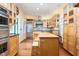 Open kitchen featuring wood cabinets, stainless steel appliances, and butcher block island at 2440 Glencoe St, Burlington, NC 27217