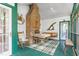 Inviting sunroom featuring a brick fireplace, swing, dining set, and rocking chair, perfect for relaxation at 2440 Glencoe St, Burlington, NC 27217