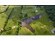 Breathtaking aerial view of a property featuring a pond and lush green landscape at 2912 Epps Clark Rd, Siler City, NC 27344