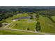 Panoramic aerial view of a home surrounded by lush greenery, a tranquil pond, and picturesque fields at 2912 Epps Clark Rd, Siler City, NC 27344