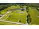 Breathtaking aerial view of a home nestled amidst serene ponds and expansive green fields at 2912 Epps Clark Rd, Siler City, NC 27344