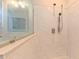 Bright bathroom featuring a glass shower with tile walls and a hand-held shower fixture at 2912 Epps Clark Rd, Siler City, NC 27344