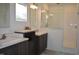 Bright bathroom featuring dual sinks, a glass-enclosed shower, and modern fixtures for a clean, updated look at 2912 Epps Clark Rd, Siler City, NC 27344