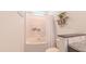 Bright bathroom featuring a tub/shower combo with decorative shelving and modern fixtures at 2912 Epps Clark Rd, Siler City, NC 27344
