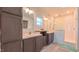 Modern bathroom featuring double sinks, updated cabinets, and a tiled shower space at 2912 Epps Clark Rd, Siler City, NC 27344