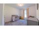 Bedroom with neutral gray walls, carpeting, and furnishings, filled with natural light from a window at 2912 Epps Clark Rd, Siler City, NC 27344