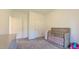 Cozy Bedroom featuring gray carpeting and a wooden crib next to a closed door at 2912 Epps Clark Rd, Siler City, NC 27344