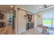 Charming dining area with a view of the backyard, a wine refrigerator, and sliding barn doors at 2912 Epps Clark Rd, Siler City, NC 27344